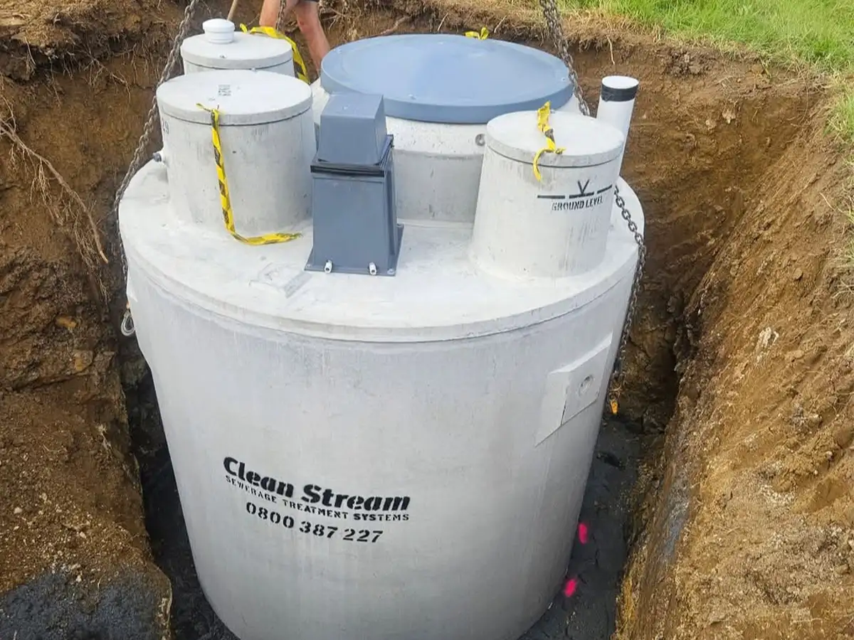 Duracrete CleanStream secondary treatment system being lowered into an excavated hole during installation in Northland